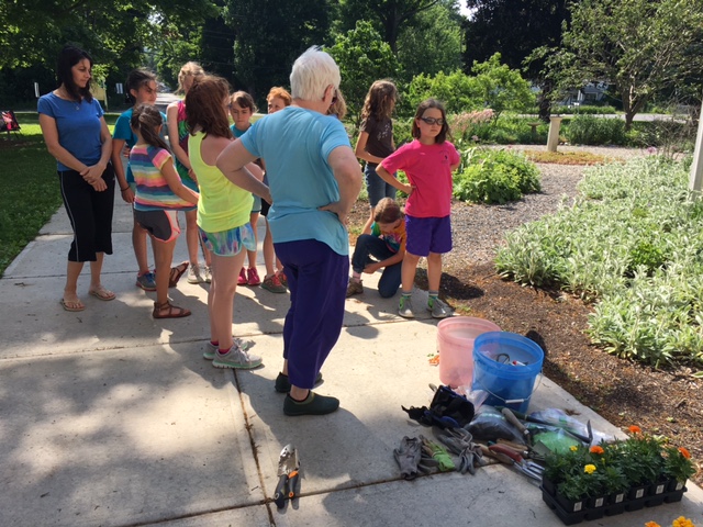 Planting marigolds at the Elizabeth Schroeder Memorial Garden